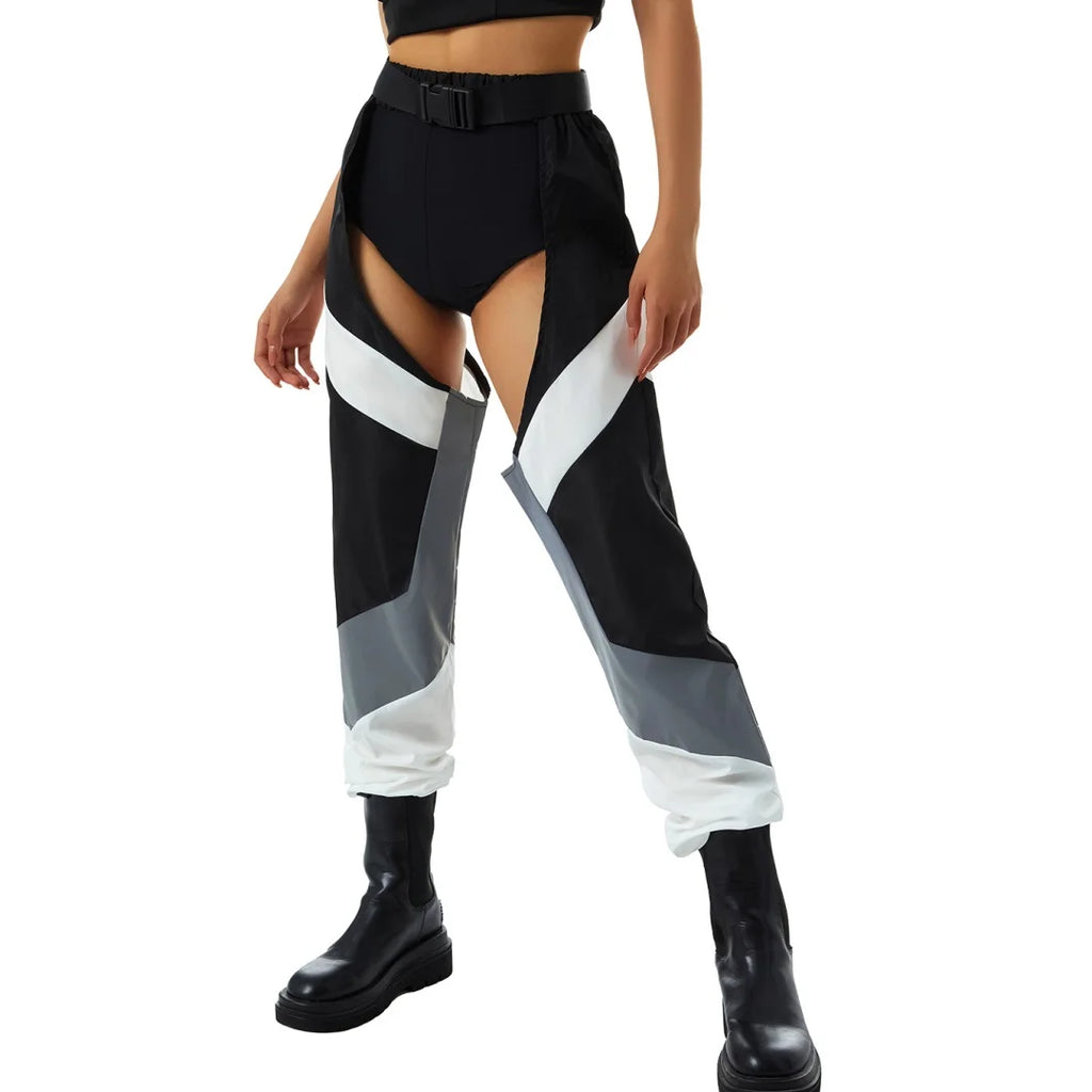 Front view of a model wearing black cargo pants with white and gray panels and buckle belt