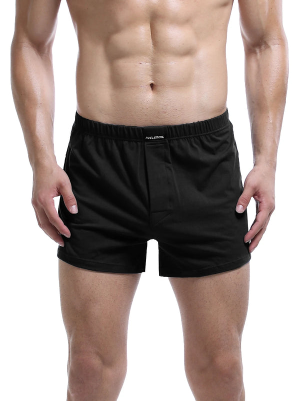 Front view of a model wearing black boxer shorts with an elastic waistband