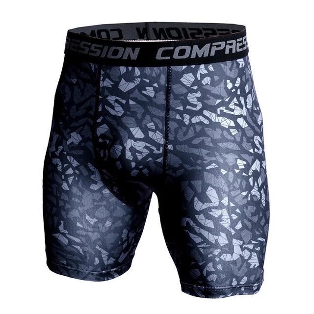Front view of black and gray geometric camouflage compression shorts with branded elastic waistband