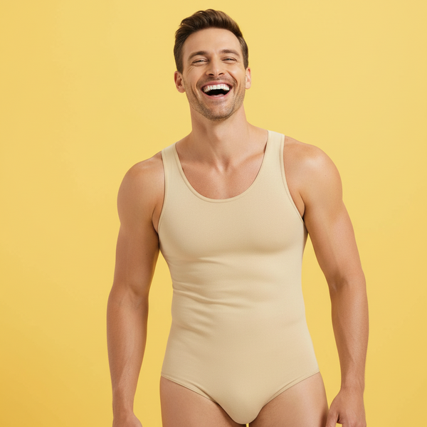 A cheerful person with short brown hair and a trimmed beard wears a beige Confidence Boost Shapewear Bodysuit