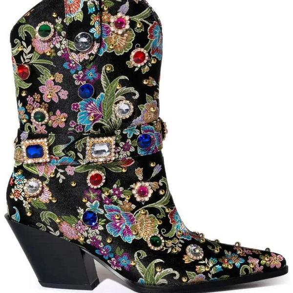 Side view of a black pointed-toe ankle boot with colorful floral embroidery and jeweled buckles