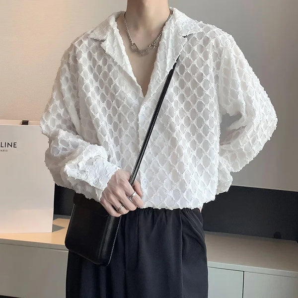 Model wearing a white open-weave collared shirt with black trousers and a shoulder bag