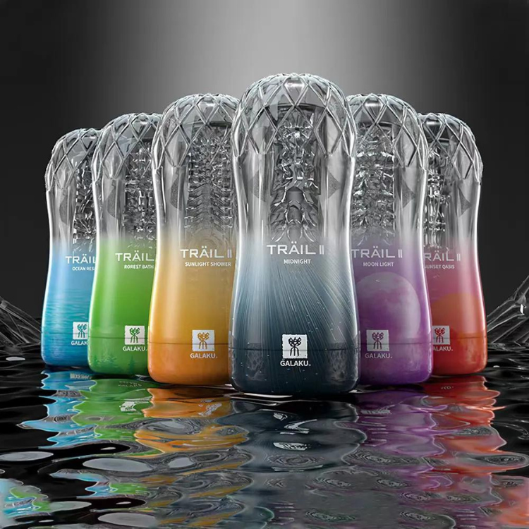 Six clear cylindrical Trail II masturbators in rainbow colors, reflected on a wet surface