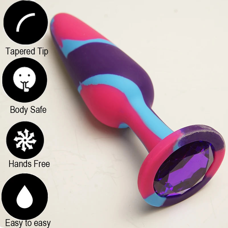 Colorful tapered butt plug with a large faceted purple jewel base