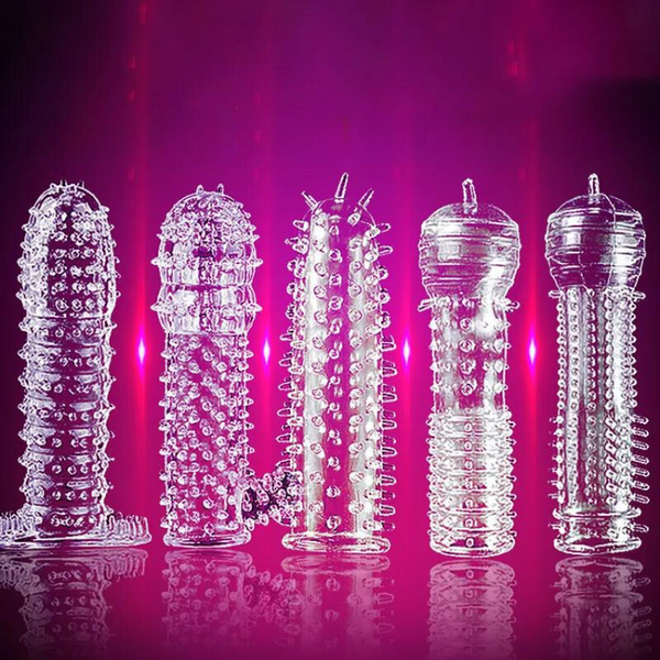 Five clear textured penis sleeves arranged upright against a vivid magenta background
