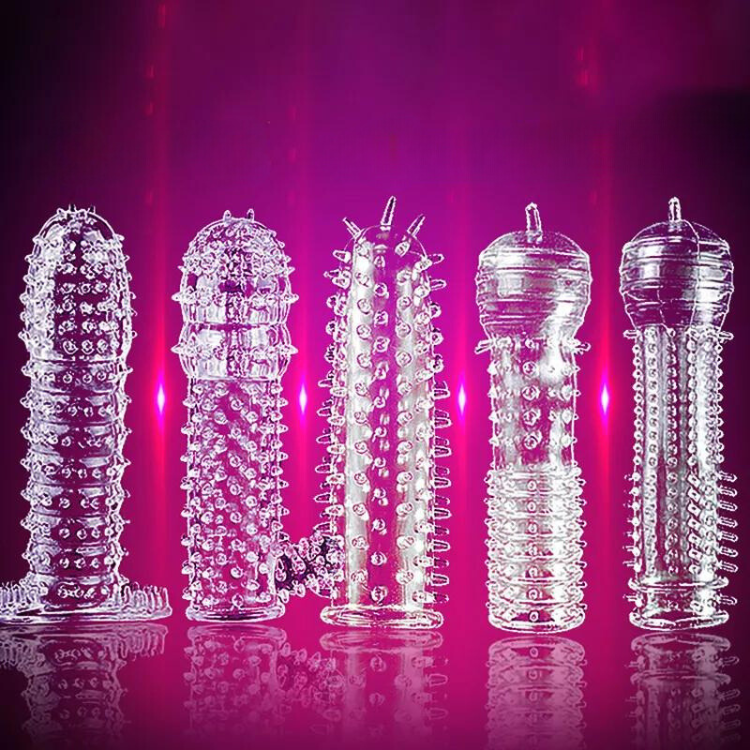Five clear textured penis sleeves arranged upright against a vivid magenta background