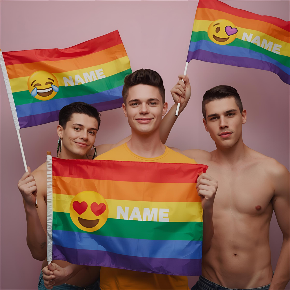 Three people hold rainbow flags reading “NAME,” with laughing, heart-eyes, and heart emojis
