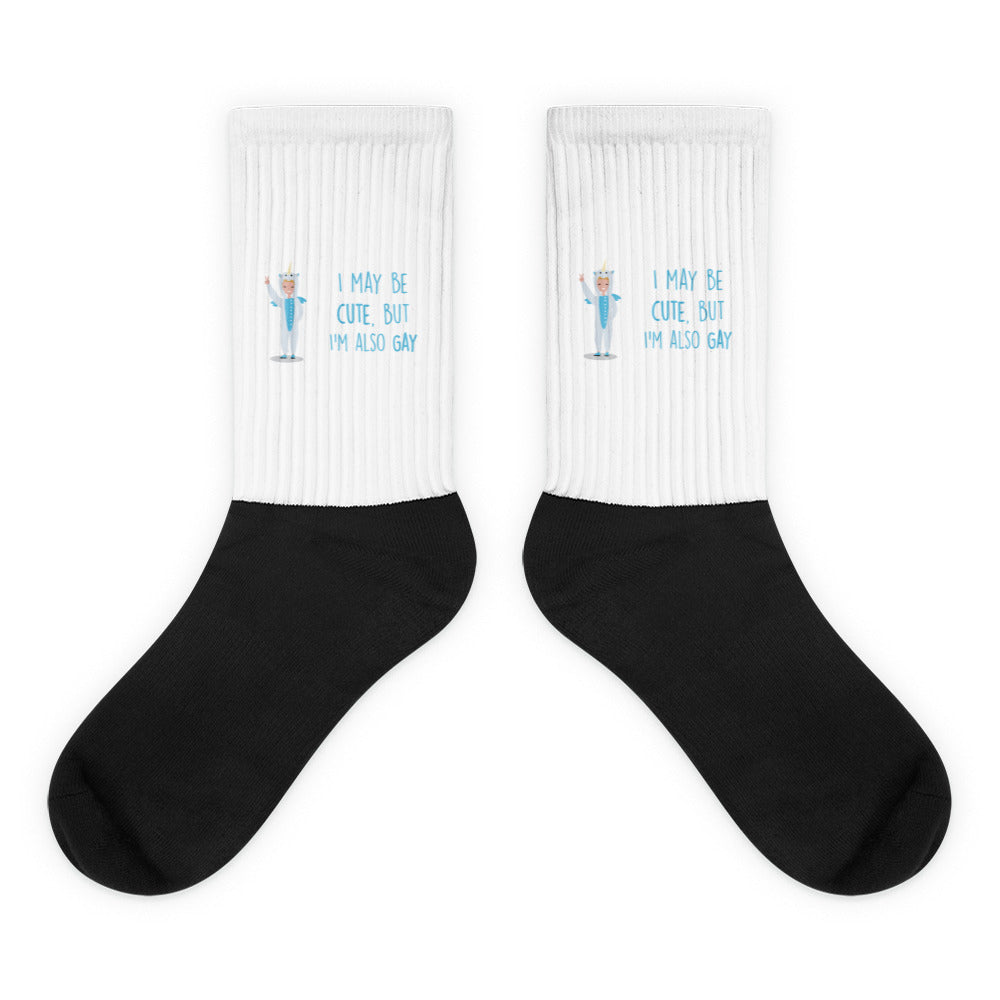 Pair of black-and-white crew socks with a unicorn and “I MAY BE CUTE, BUT I’M ALSO GAY”