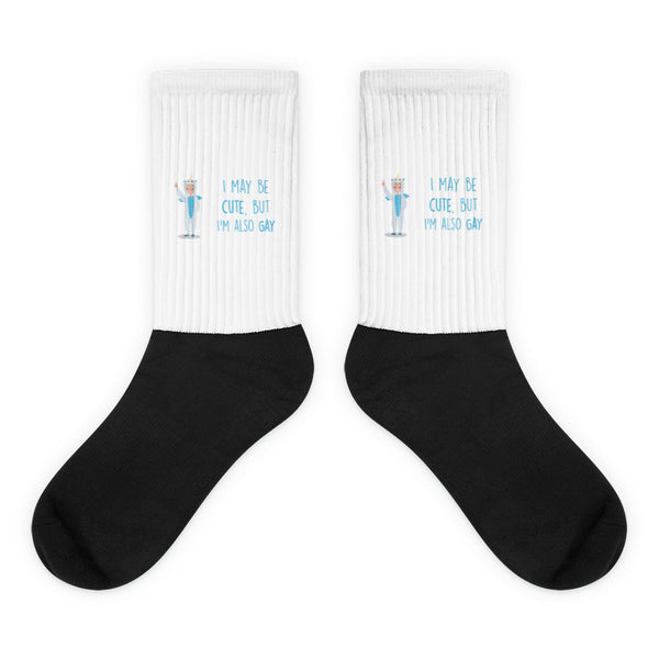 Pair of black-and-white crew socks with a unicorn and “I MAY BE CUTE, BUT I’M ALSO GAY”