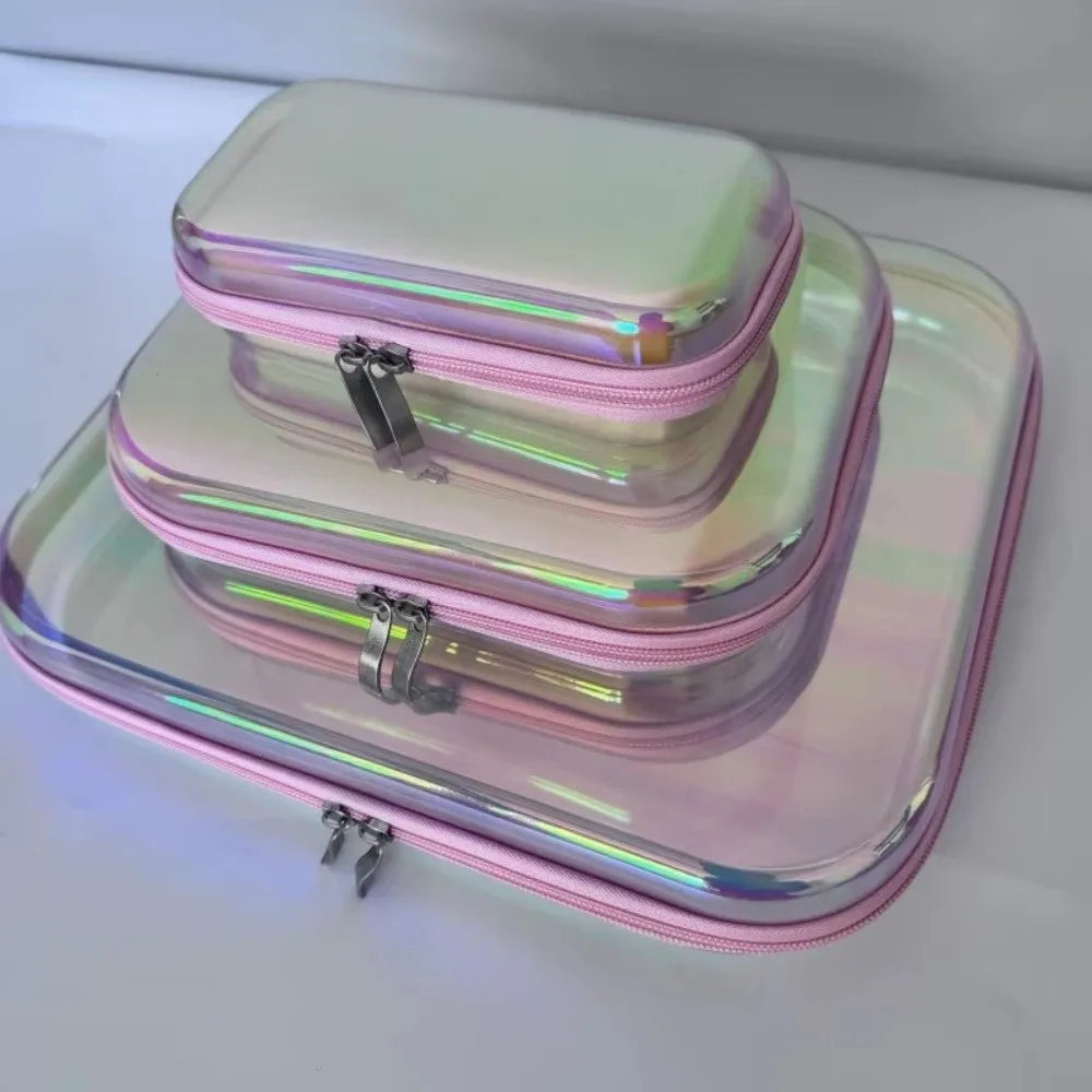 Stack of three iridescent rectangular storage boxes with pink zippers