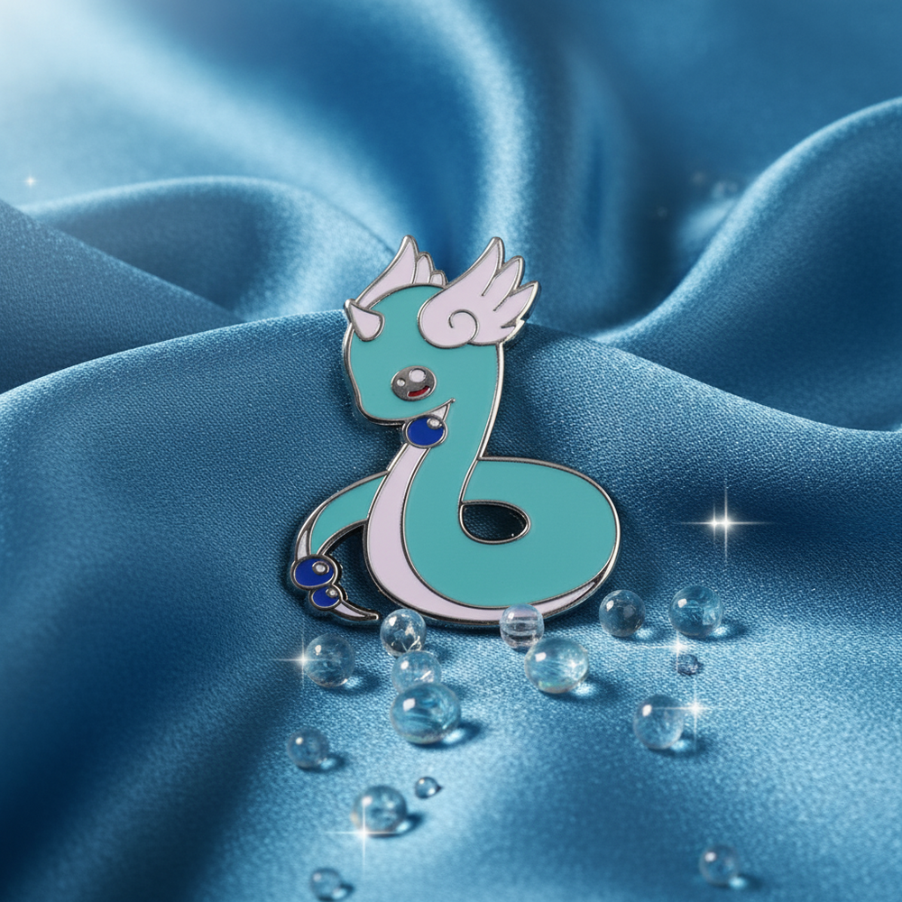 Cute Dratini Enamel Pin: A mint-green, snake-like dragon with a unicorn horn and bead accents