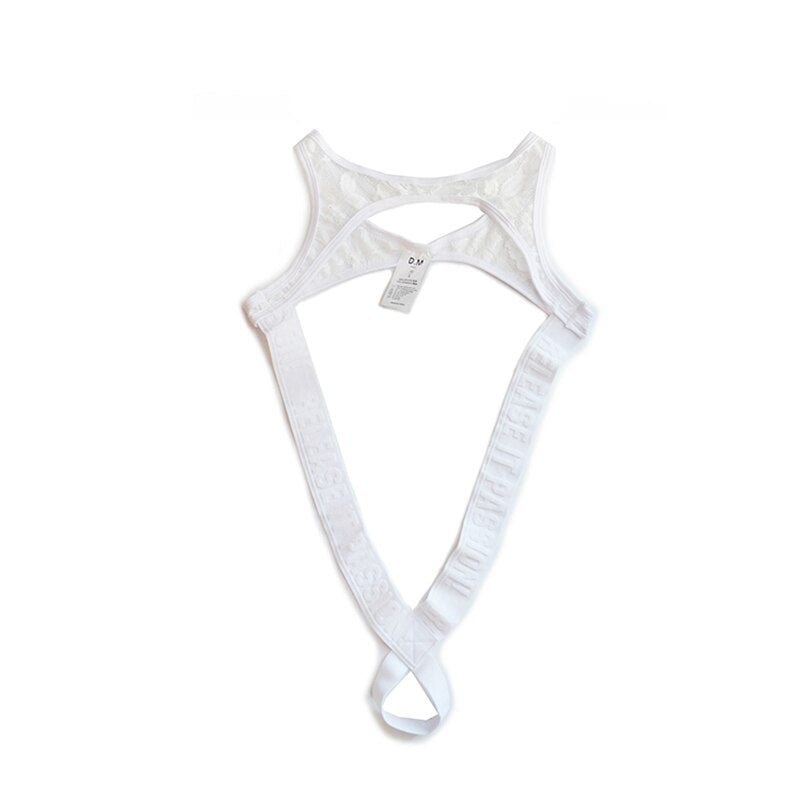 White lace thong bodysuit laid flat, with a chest cutout and crossed straps forming a bottom loop