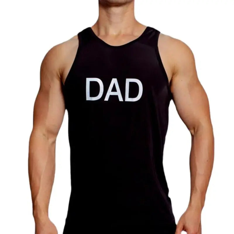 Front view of a muscular model wearing a black sleeveless tank top marked “DAD” in white