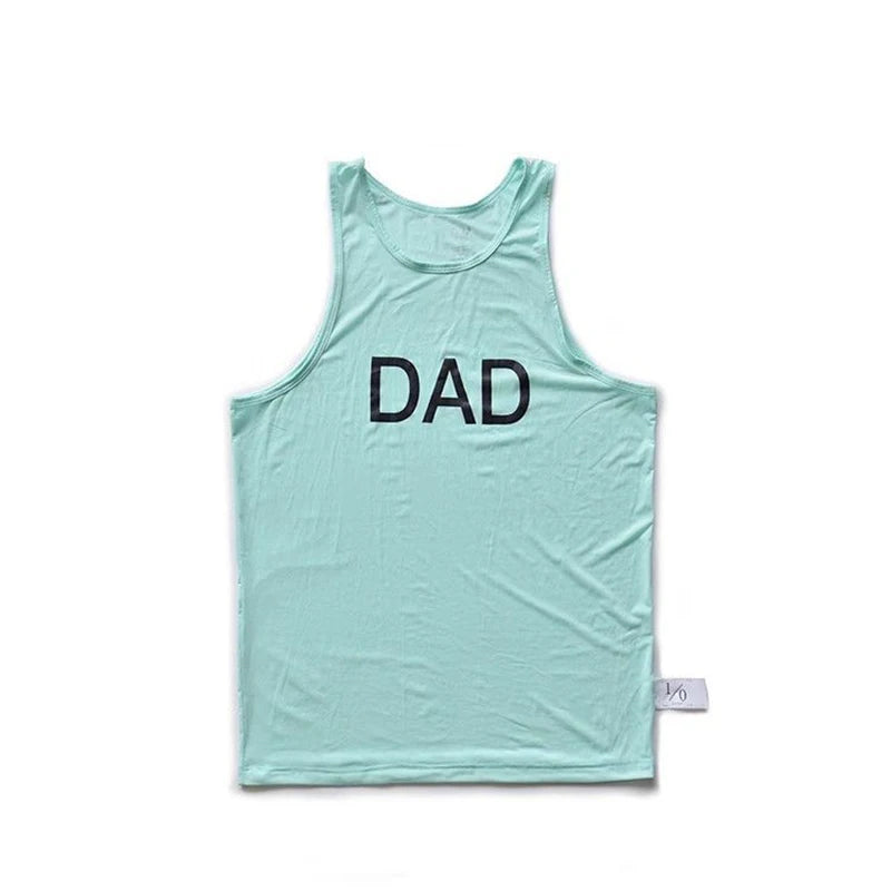 Flat-lay mint green tank top with black “DAD” lettering on the chest
