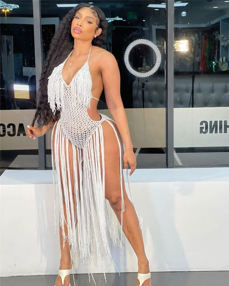 Model wearing a white crochet dress with fringe and high side slits