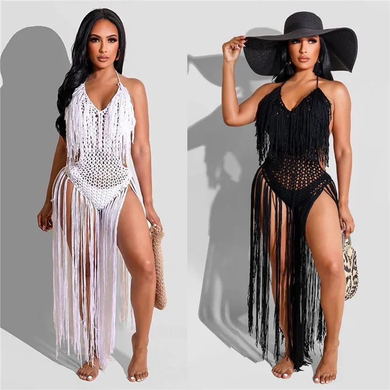 Two models wear white and black fringed crochet swimsuit cover-ups; one holds a wide-brim hat