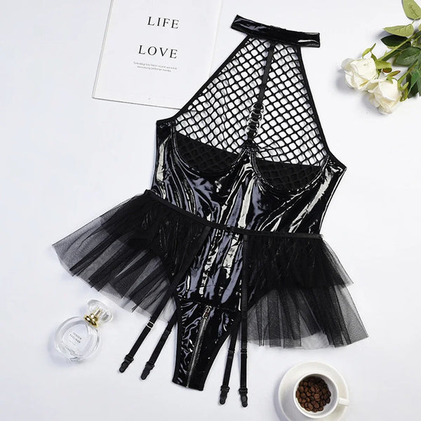 Flat lay of a black glossy PU bodysuit with fishnet cups, tulle skirt, and garter straps