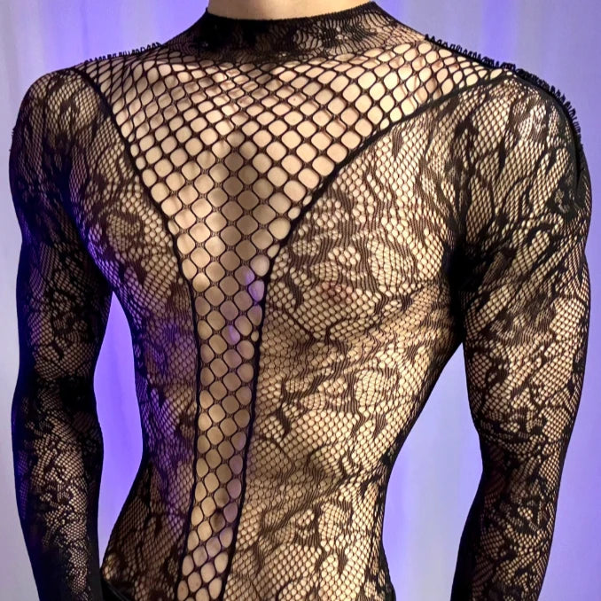 Front view of a sheer black lace bodysuit on a model, with fishnet panels and long sleeves