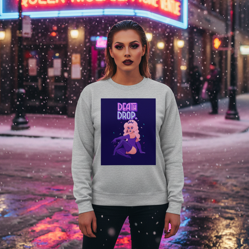 Model wearing a light-gray sweatshirt with a neon “DEATH DROP” drag-queen graphic in falling snow