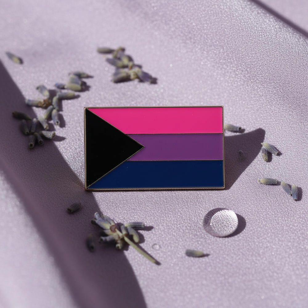 Rectangular pink, purple, and blue pride flag pin with a black triangle on lavender fabric