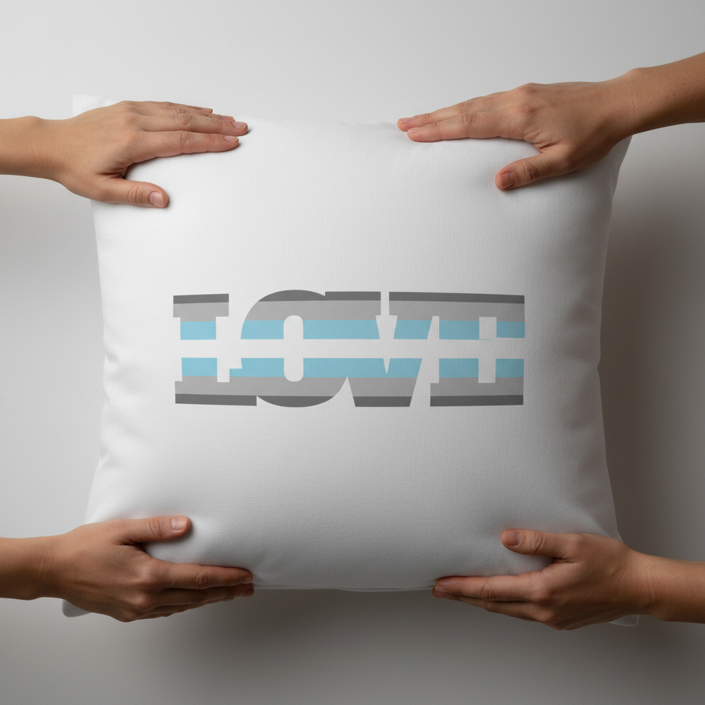 Demiboy Love Pillow, white with bold striped "LOVE" text, held by four hands; a modern queer home accent cushion.