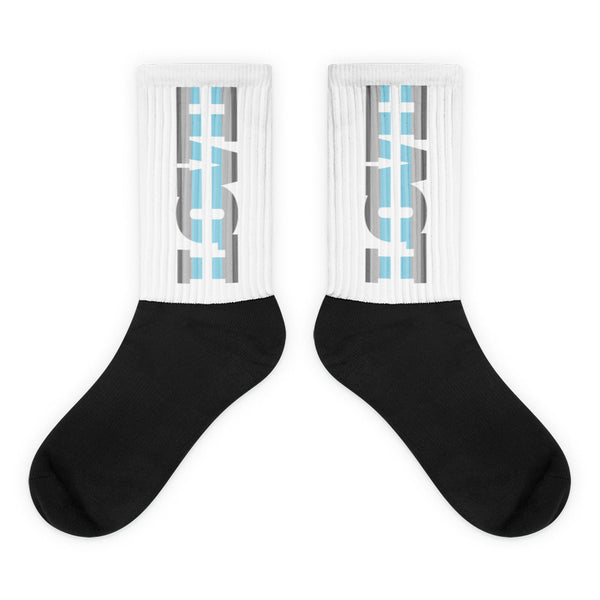 Pair of black-toe crew socks with white ribbed cuffs and blue-gray graphics