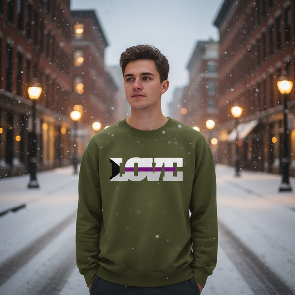 Person wearing an olive-green sweatshirt with white LOVE lettering and a purple stripe in falling snow