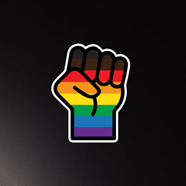 Raised fist magnet with horizontal rainbow Pride flag stripes on a black background