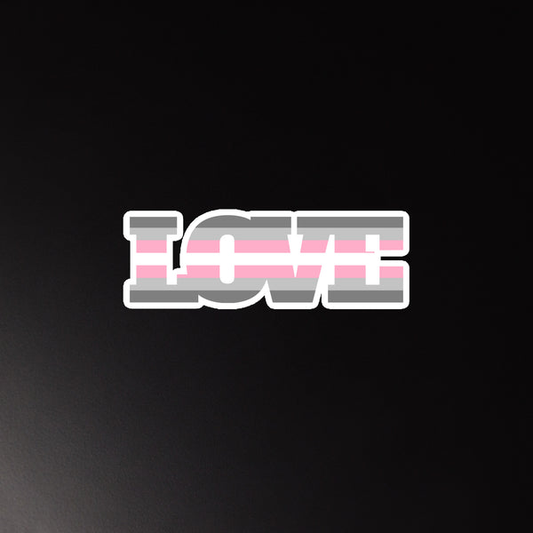 Demigirl Love Magnet with bold LOVE in pink, gray, and white stripes on a black background; a flexible, matte-finished vinyl magnet celebrating queer pride and self-expression.