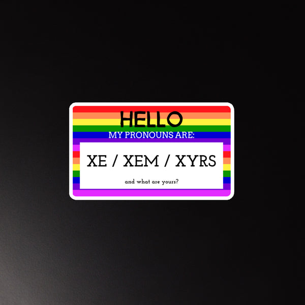 Magnet with a rainbow border on black, showing “HELLO MY PRONOUNS ARE: XE / XEM / XYRS”—a bold nod to queer pride.