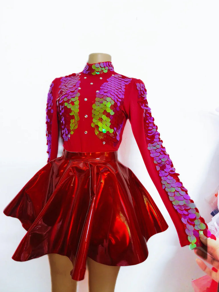 Front view of a mannequin in a red sequin-sleeved top and glossy flared skirt