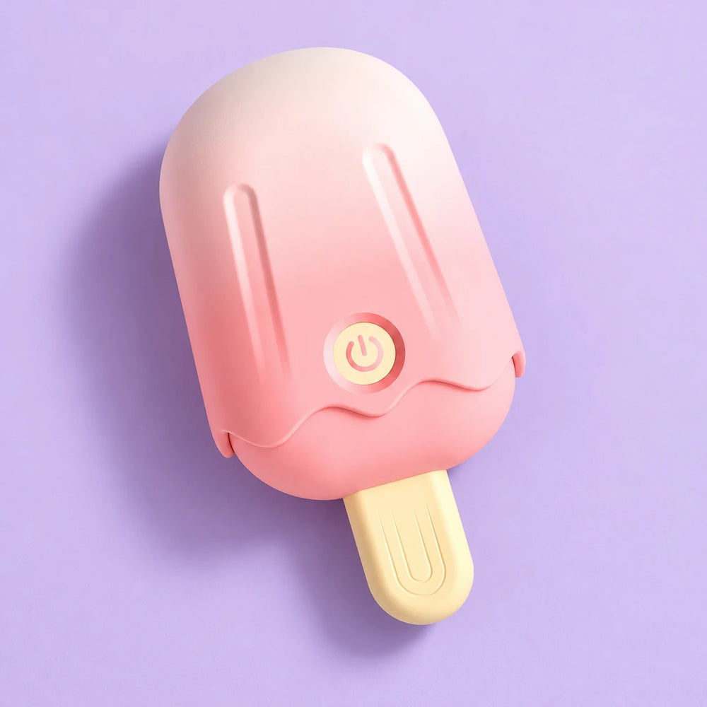Pink ice-cream clitoris vibrator with its cap fitted and cream stick handle, lying diagonally on lavender.