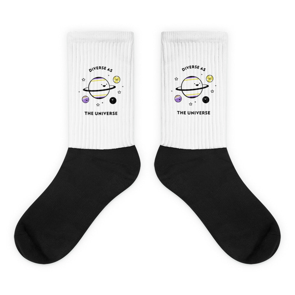Pair of black-and-white socks with planets and “DIVERSE AS THE UNIVERSE” text