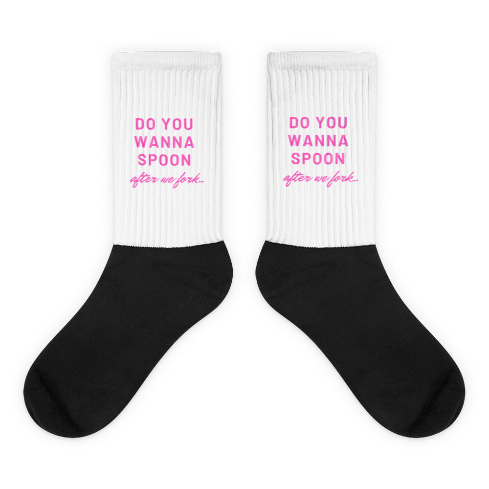 Pair of black-and-white crew socks reading “DO YOU WANNA SPOON after we fork...”