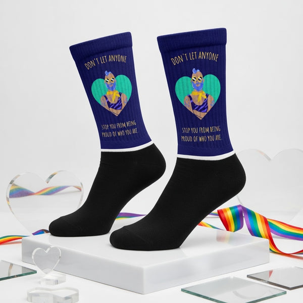 Crew socks with navy cuffs, masked latex figure over green heart, rainbow ribbons, clear hearts