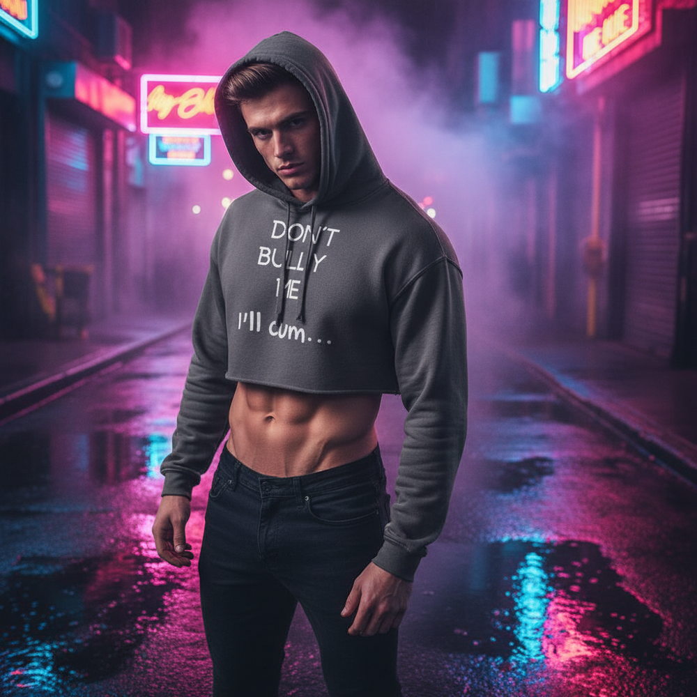 Don't Bully Me, I'll Cum crop hoodie on a fit person in neon-lit city at night, abs out in vibrant pink and blue queer glow