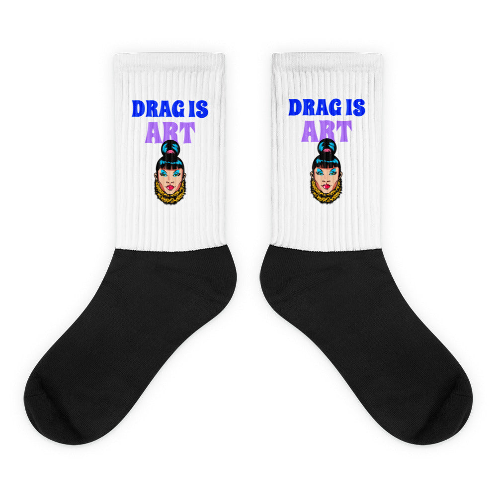 Pair of black-and-white socks with “DRAG IS ART” and drag performer portraits