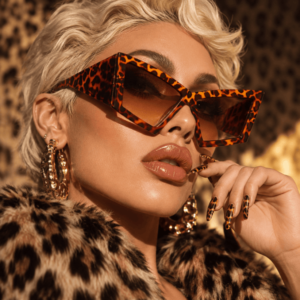 Close-up model wearing oversized tortoiseshell cat-eye sunglasses