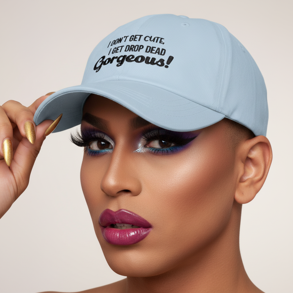 Drop Dead Gorgeous Cap: pale blue pride hat, black “I dont get cute, I get drop dead gorgeous!” slogan