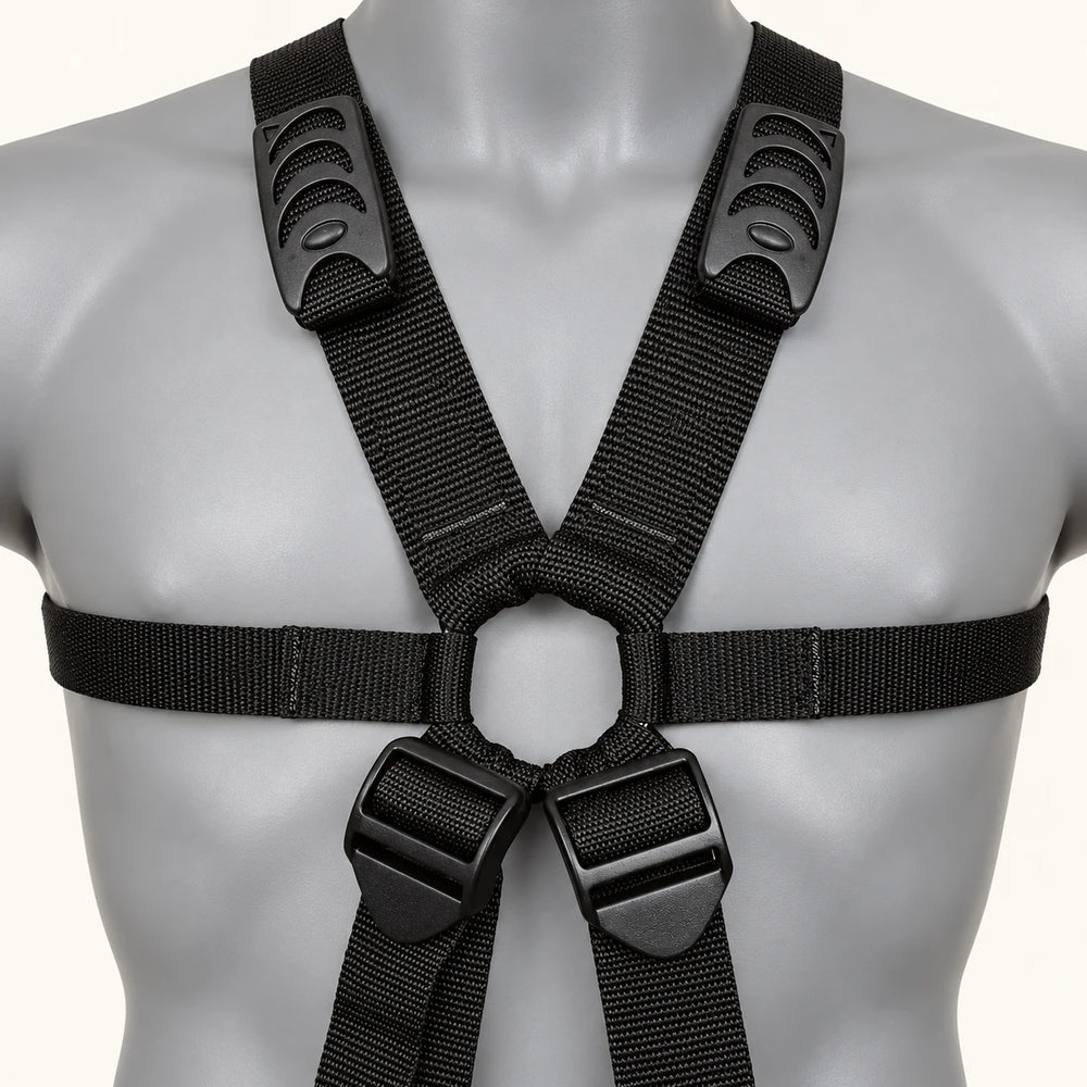Front detail of the Dual Delight sling harness on a grey display bust, showing black webbing, adjustment buckles and central ring.