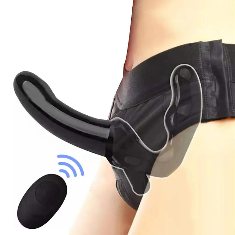 Side view of a black strapless dildo harness worn at the hips, with a wireless remote