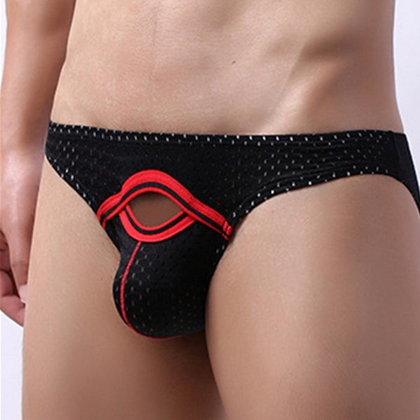 Close-up front view of a model wearing black mesh briefs with red trim and an open access pouch