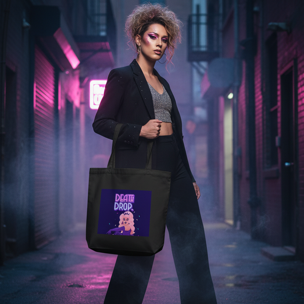 Model holding a black tote with a colorful “DEATH DROP” cartoon graphic in a neon-lit alley