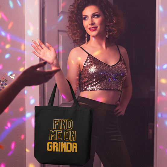 Person in a vibrant party setting holds the Find Me On Grindr Eco Tote Bag, an organic cotton tote with bold yellow lettering, embodying queer pride and self-expression in a fun, inclusive atmosphere.