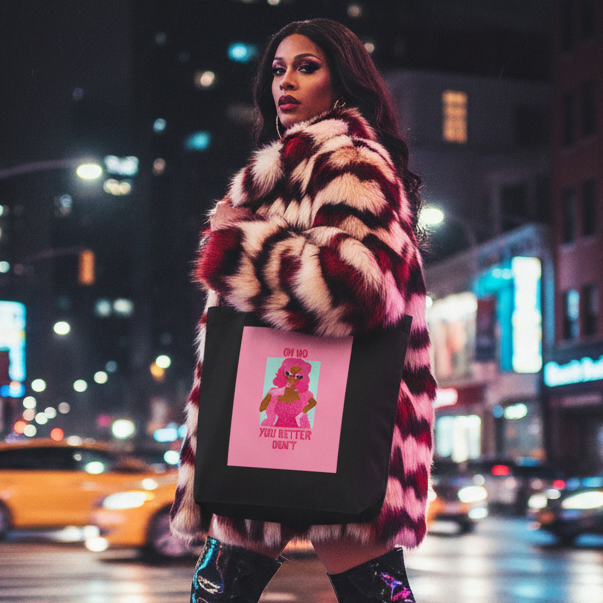 A fashion-forward individual confidently struts with the Oh No You Better Don't Eco Tote Bag, showcasing bold self-expression with its pink graphic on black organic cotton, embodying queer pride and empowerment.