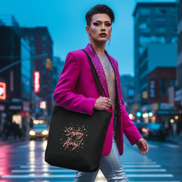 Sashay Away Eco Tote Bag slung over shoulder, glittery lettering shines on an organic cotton tote. Person confidently struts in metallic pants, embodying prideful, bold queer visibility on a neon-lit city street.