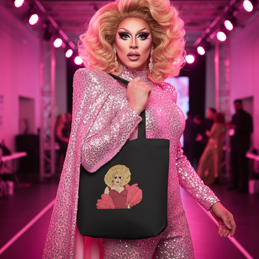Model holding the Sassy Trixie Mattel Eco Tote Bag, adorned with a glamorous illustration on black organic cotton, exuding queer pride and eco-conscious style, perfect for showcasing self-expression and empowerment.