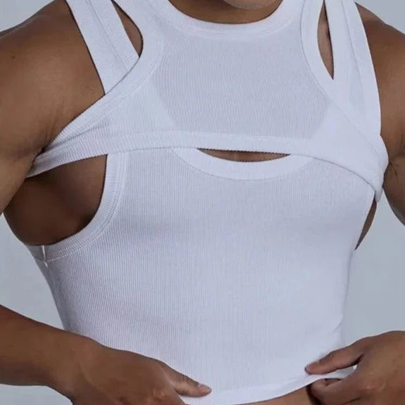 Close-up of a person wearing a white ribbed crop top with layered straps and cutouts