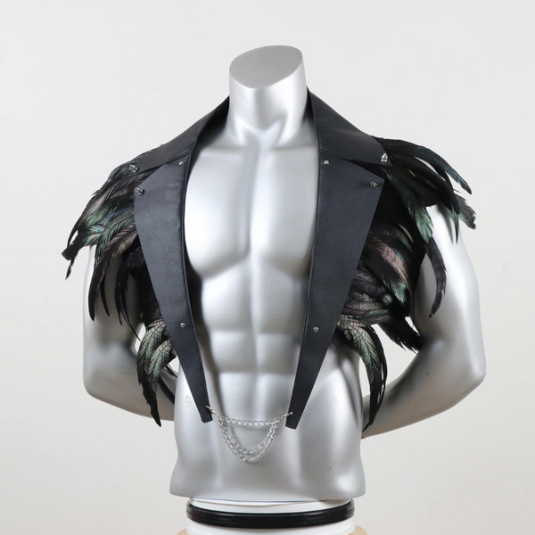 Front view of a black leather shoulder harness with feathered panels and silver chains on a mannequin