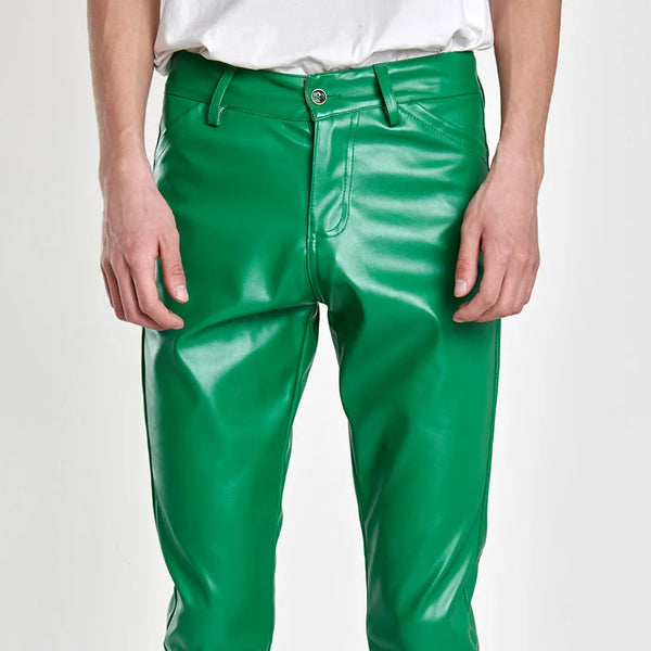 Front view of a model wearing bright green, slim-fit faux-leather pants